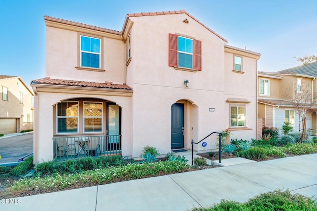 mediterranean / spanish-style home with a porch