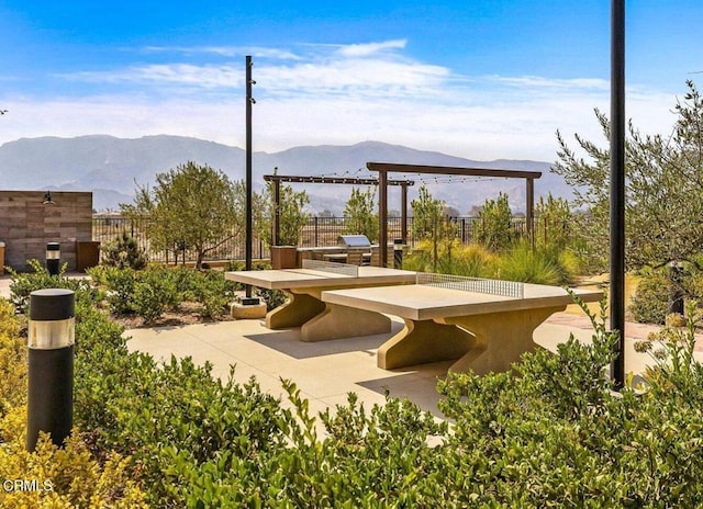 view of home's community with a mountain view and a patio area