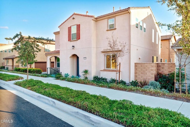 mediterranean / spanish-style house featuring a garage