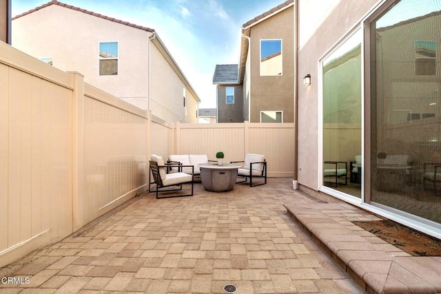 view of patio featuring an outdoor living space with a fire pit