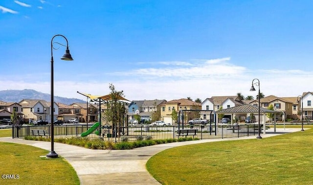 view of property's community with a residential view, a lawn, playground community, and a gazebo