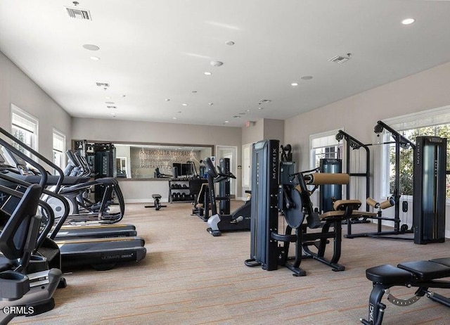 exercise room with recessed lighting, visible vents, and light carpet