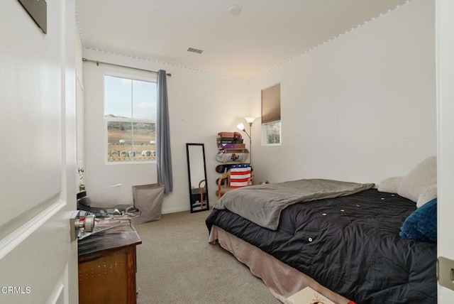 bedroom featuring light carpet and visible vents