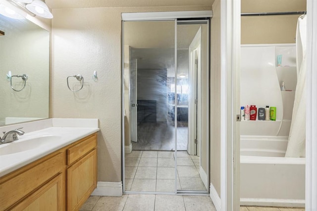 bathroom with tile patterned flooring, vanity, and shower / bathtub combination with curtain