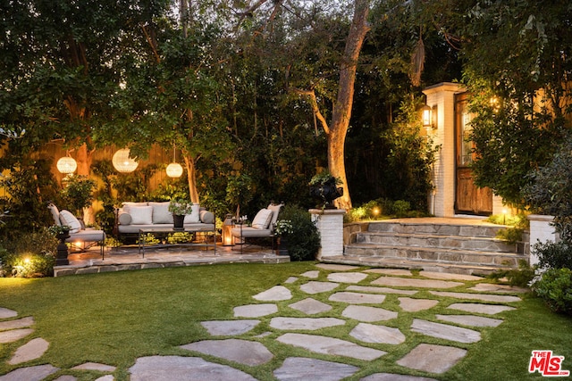 view of yard with an outdoor living space and a patio area