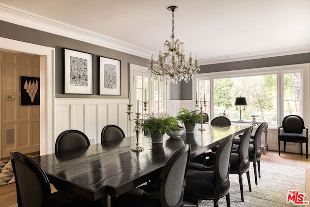 dining room featuring crown molding, a chandelier, and hardwood / wood-style flooring