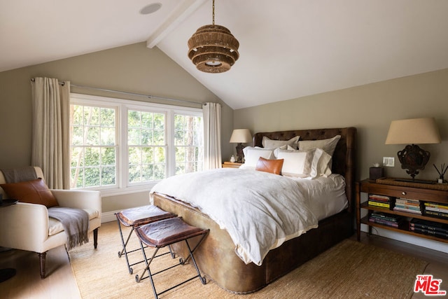 bedroom with lofted ceiling with beams and light wood-type flooring