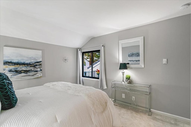 carpeted bedroom with vaulted ceiling