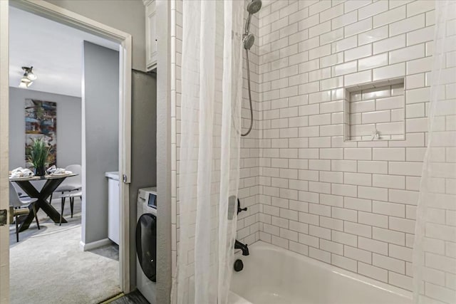 bathroom featuring washer / dryer and shower / tub combo