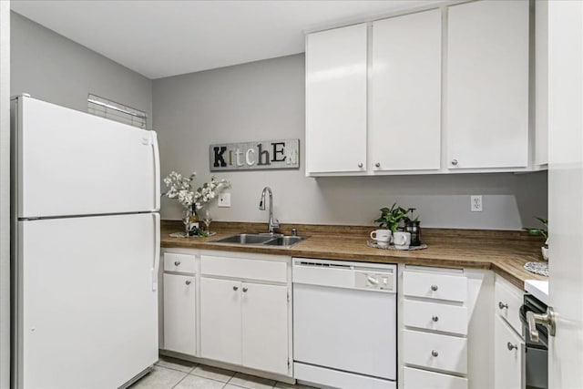 kitchen featuring sink, white appliances, light tile patterned floors, white cabinetry, and wood counters