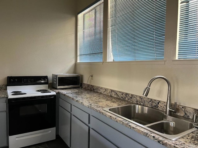 kitchen with electric range oven and sink