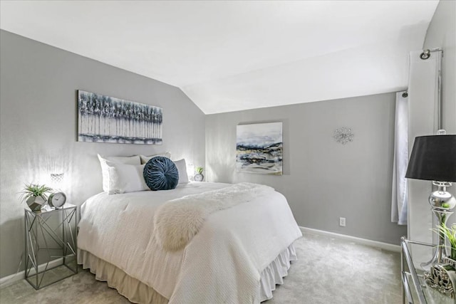 bedroom featuring carpet floors and vaulted ceiling