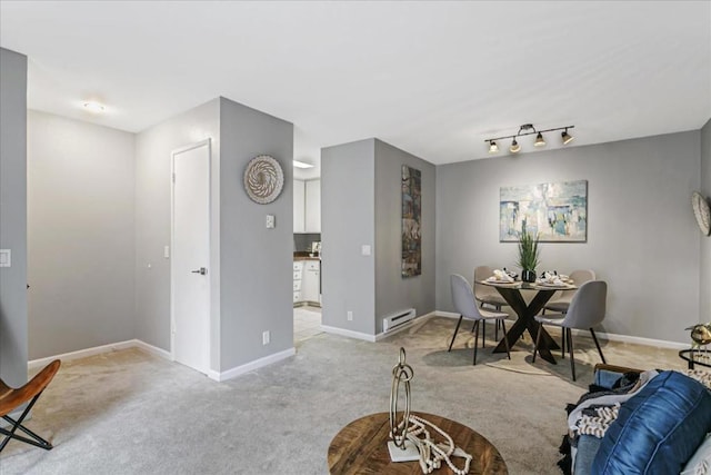 dining area with light carpet and a baseboard heating unit