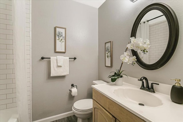 bathroom featuring vanity, wood-type flooring, and toilet