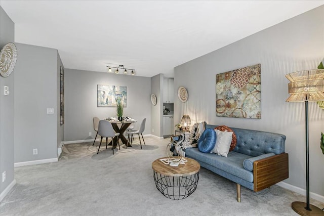 living room featuring track lighting and carpet