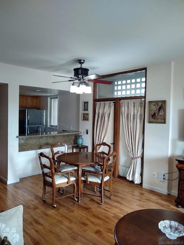 dining area featuring hardwood / wood-style flooring and ceiling fan