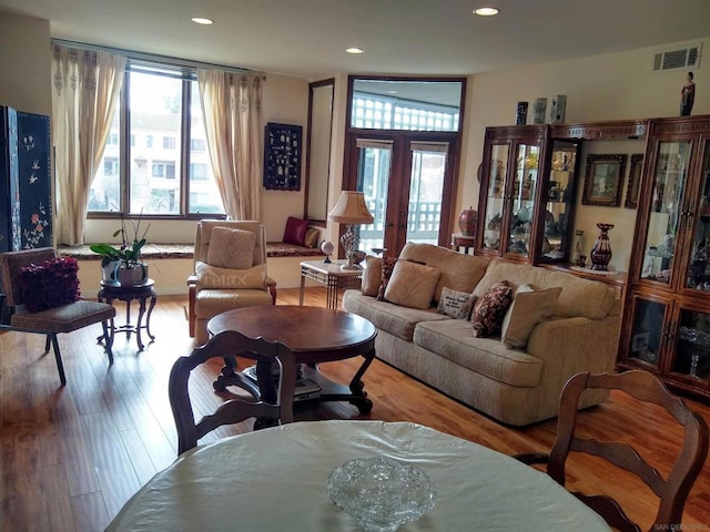 living room with wood-type flooring and french doors