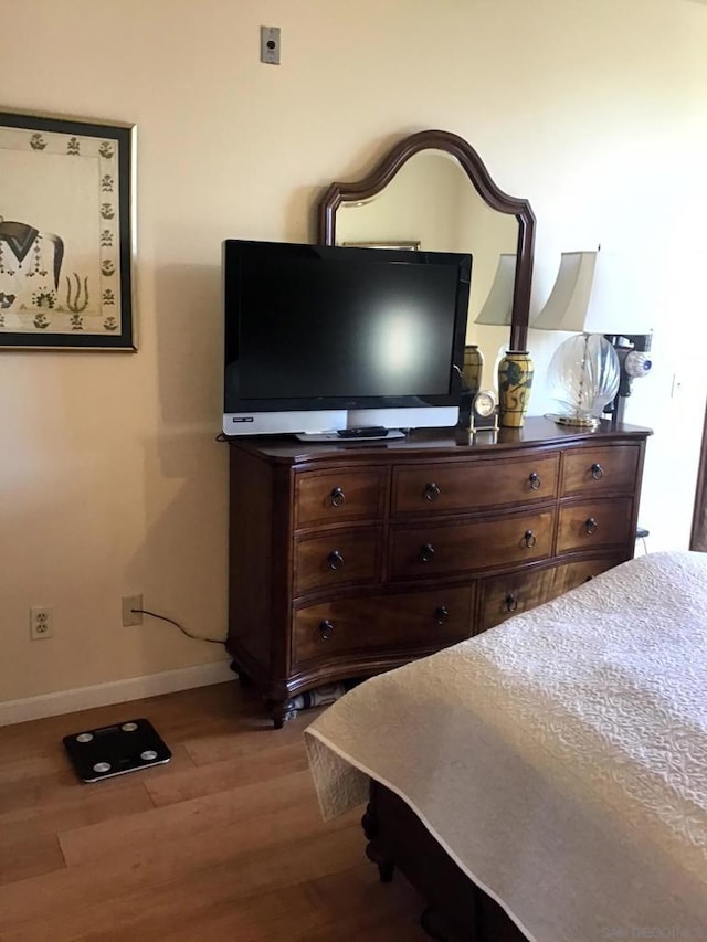 bedroom with hardwood / wood-style flooring