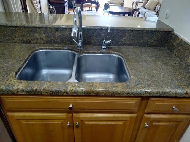 room details with sink and dark stone countertops