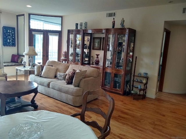 living room featuring wood-type flooring and french doors