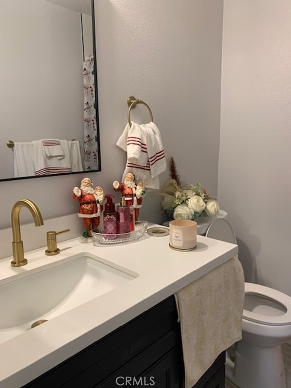 bathroom with vanity and toilet