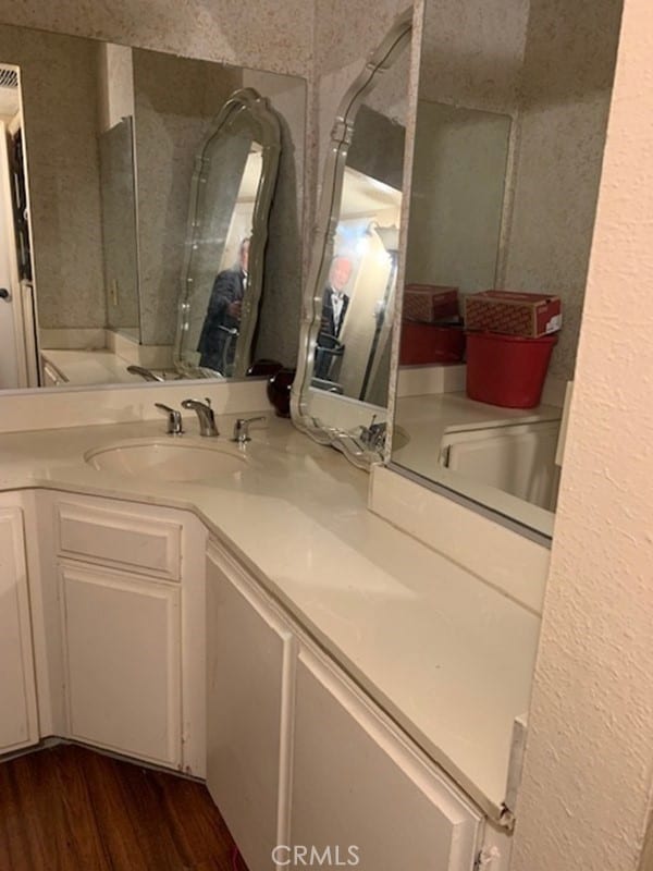 bathroom featuring hardwood / wood-style flooring and vanity