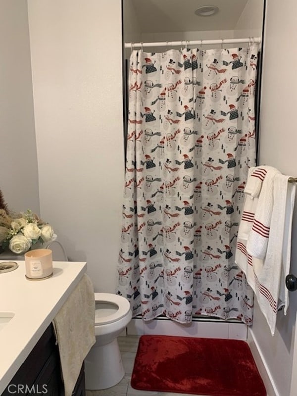 bathroom featuring vanity, toilet, curtained shower, and tile patterned flooring