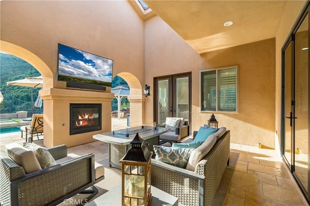 view of patio / terrace with an outdoor living space with a fireplace