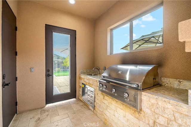 entryway with a sink, stone tile flooring, and recessed lighting