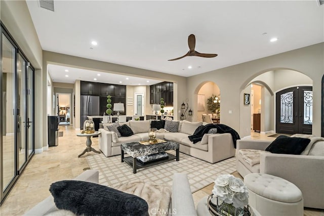 living room with arched walkways, french doors, recessed lighting, visible vents, and ceiling fan