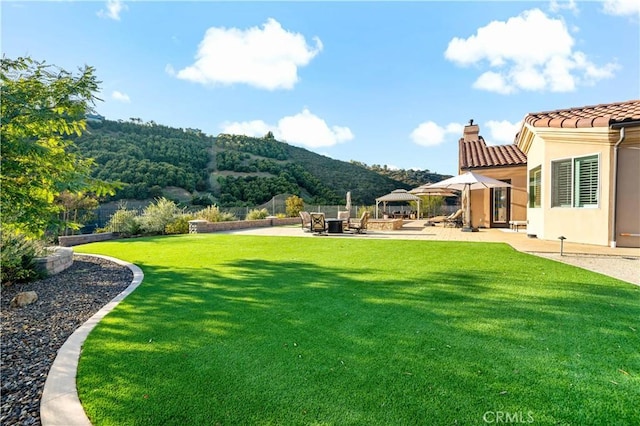 view of yard with a patio area, fence, a mountain view, and a gazebo