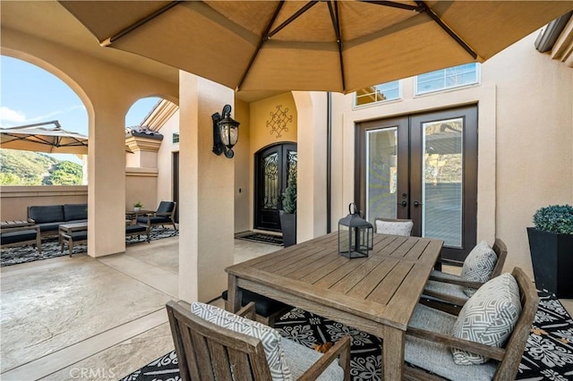 view of patio featuring outdoor dining space, french doors, and an outdoor hangout area