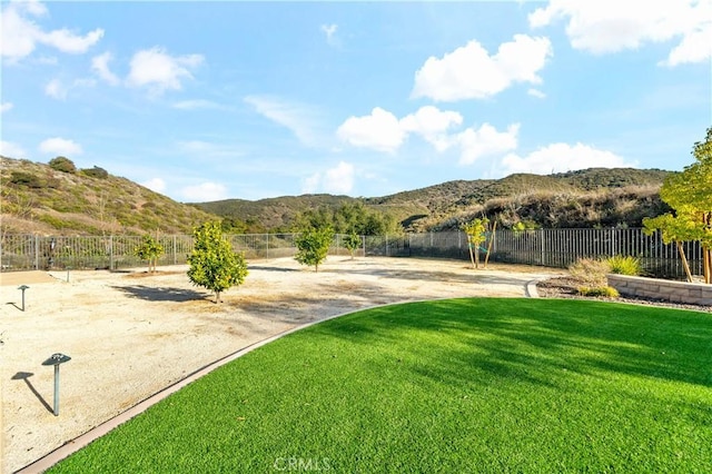 exterior space with fence and a mountain view