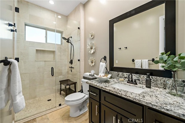 bathroom with toilet, a shower stall, recessed lighting, and vanity