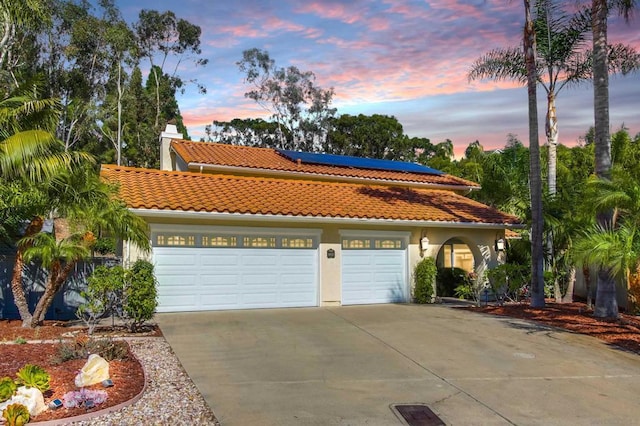 mediterranean / spanish-style home featuring solar panels