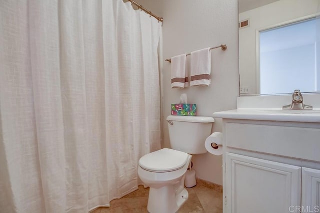 bathroom featuring vanity, tile patterned floors, and toilet