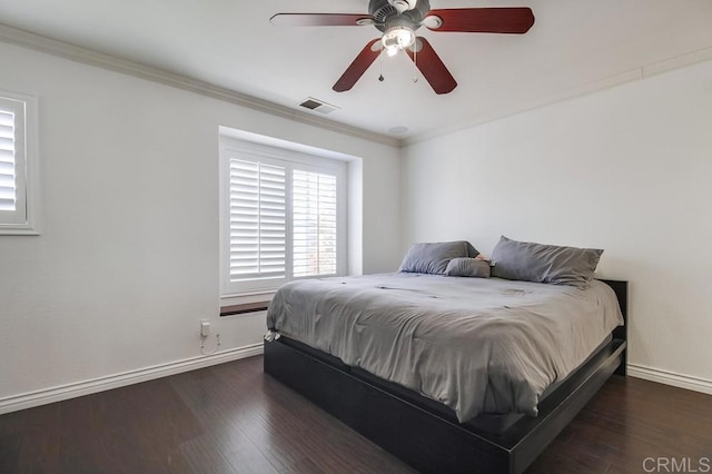 bedroom featuring ornamental molding, ceiling fan, and dark hardwood / wood-style flooring