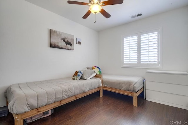 bedroom featuring dark hardwood / wood-style flooring and ceiling fan