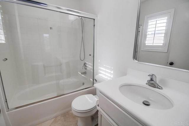 full bathroom with vanity, bath / shower combo with glass door, tile patterned floors, and toilet