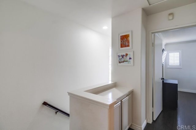 corridor with dark hardwood / wood-style flooring