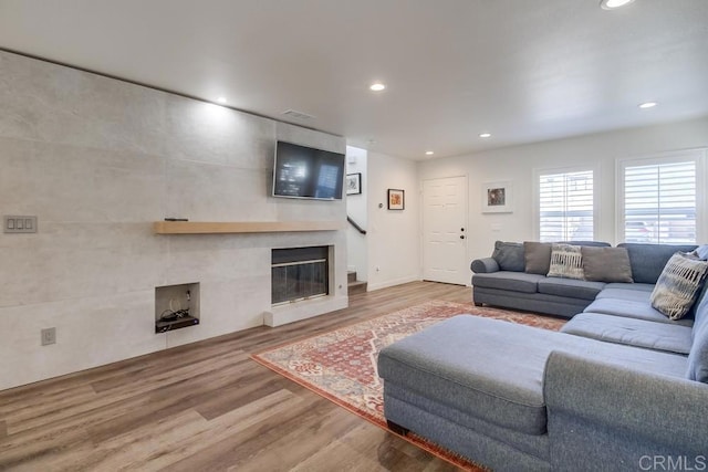 living room with a fireplace and hardwood / wood-style floors