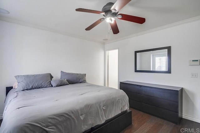 bedroom featuring dark wood-type flooring, ceiling fan, and crown molding