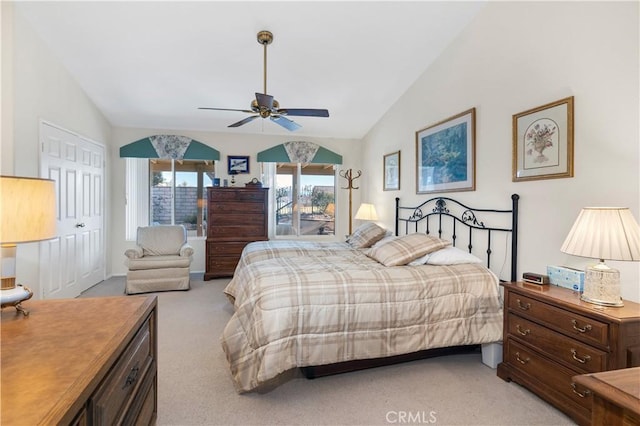 carpeted bedroom with vaulted ceiling and ceiling fan