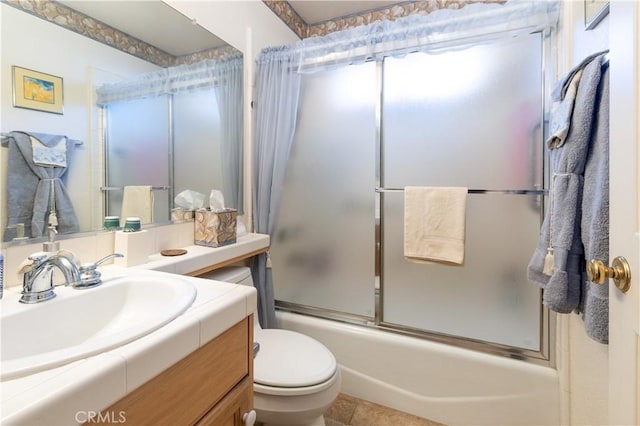 full bathroom with vanity, tile patterned flooring, toilet, and combined bath / shower with glass door