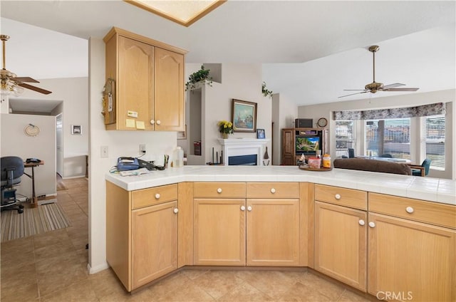 kitchen featuring ceiling fan, light brown cabinetry, and kitchen peninsula