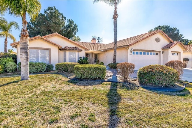 mediterranean / spanish-style home with a garage and a front yard