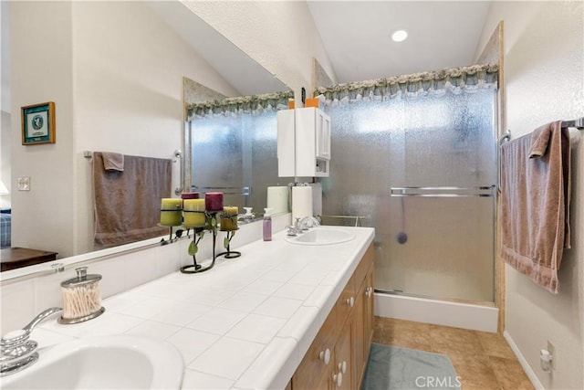 bathroom featuring tile patterned floors, vanity, a shower with shower door, and lofted ceiling