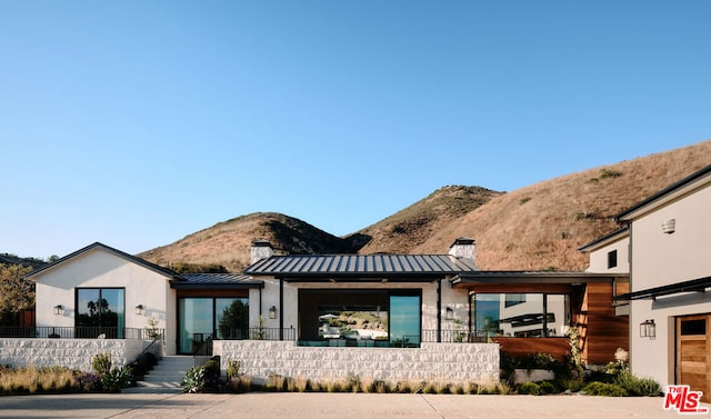 rear view of property featuring a mountain view