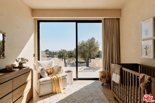 bedroom with access to exterior and light hardwood / wood-style floors