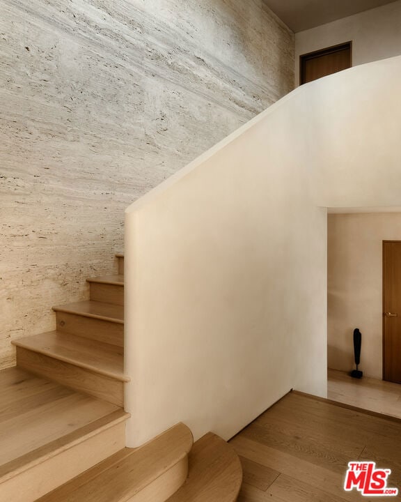 stairs with hardwood / wood-style floors